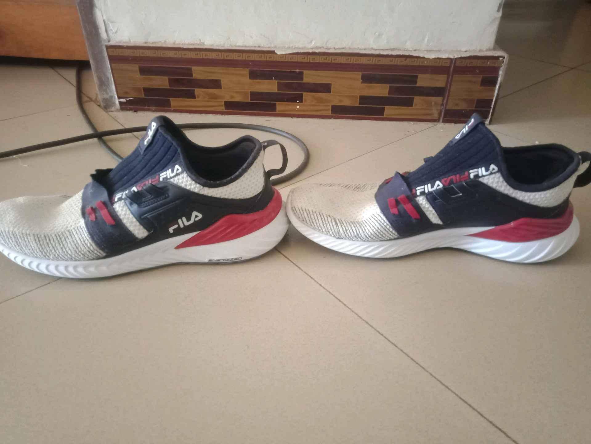 USED WHITE AND NAVY BLUE FILA SHOES for sale in Kampala - Yilick